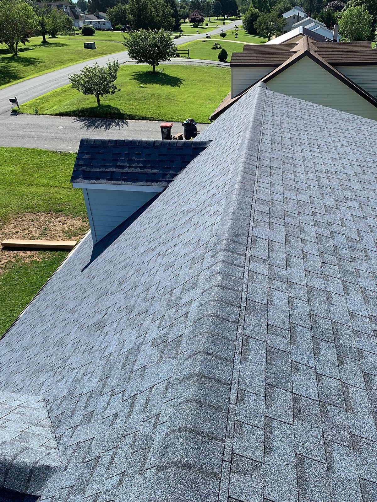 The roof of a house with a gray shingle roof.