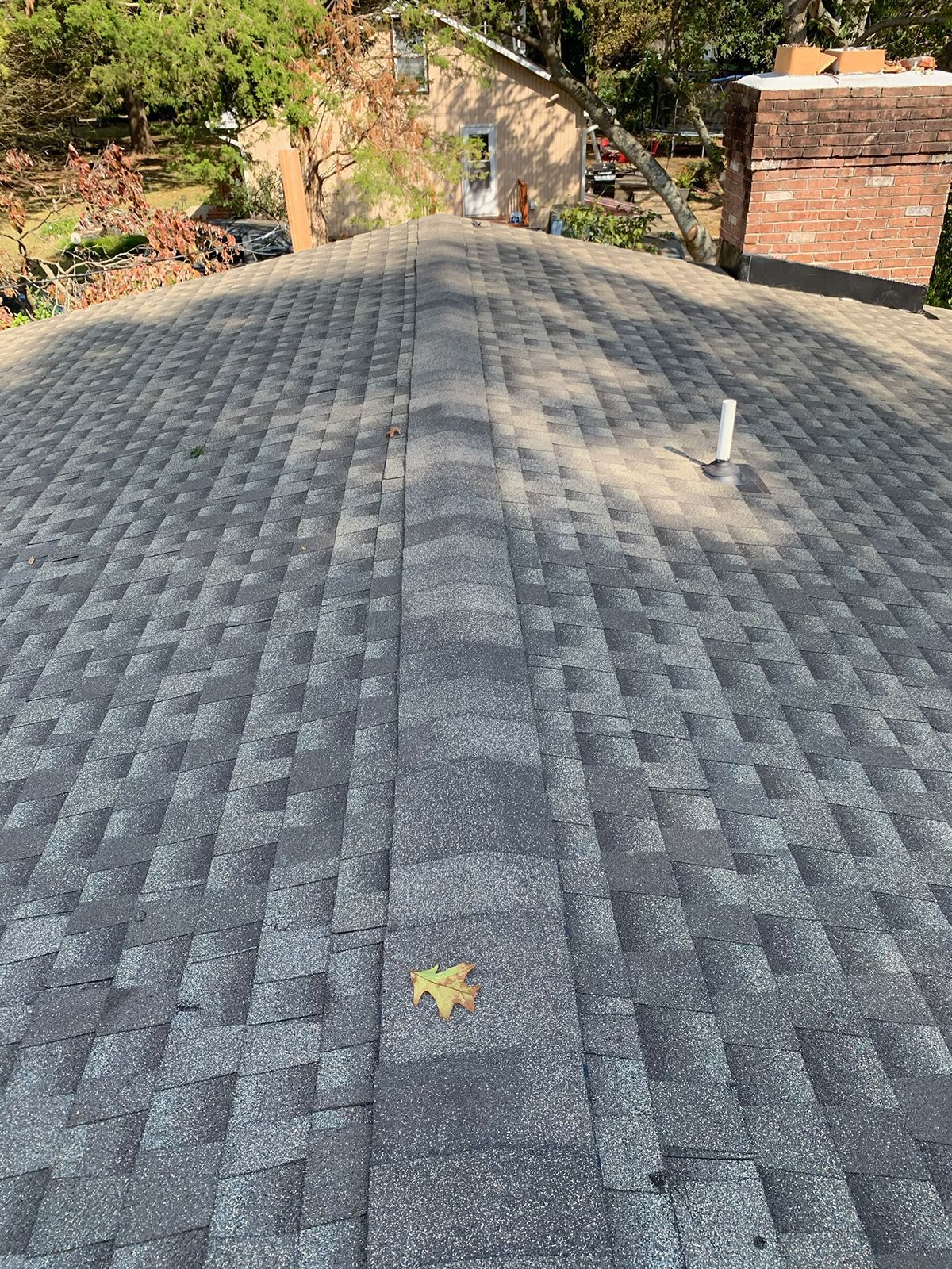 A close up of a roof with a leaf on it.