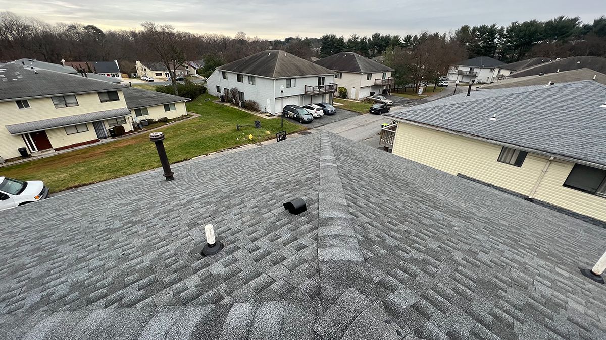 An aerial view of a roof of a house in a residential area.