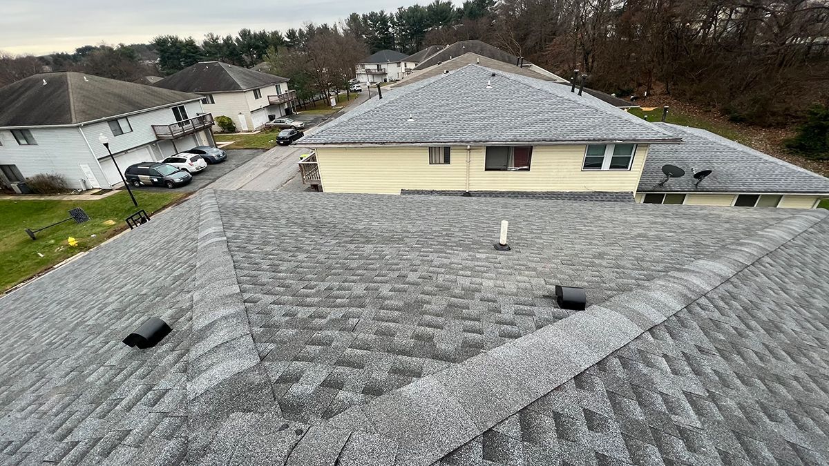 An aerial view of a house with a gray roof.