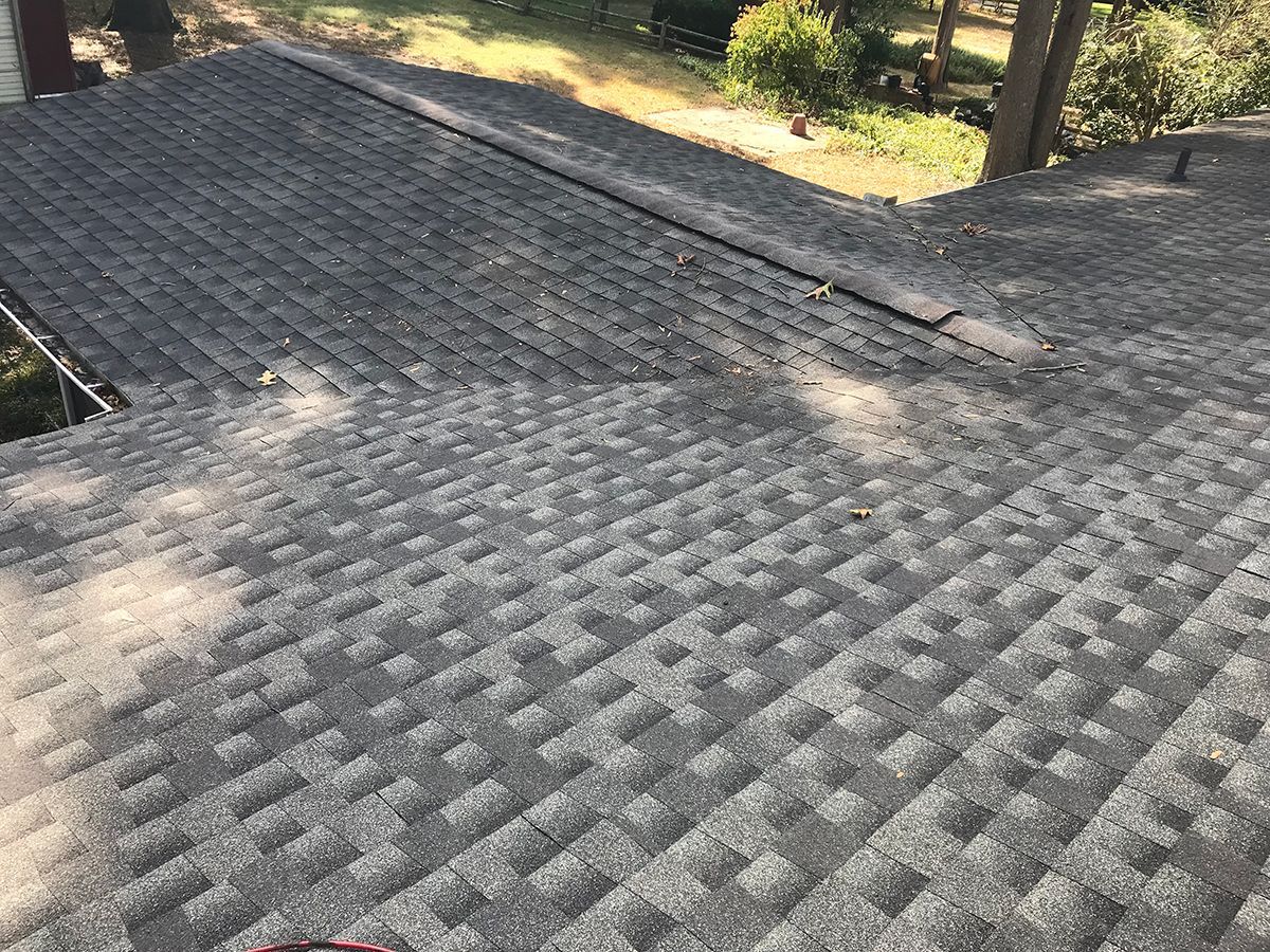 A close up of a roof with a lot of shingles on it.