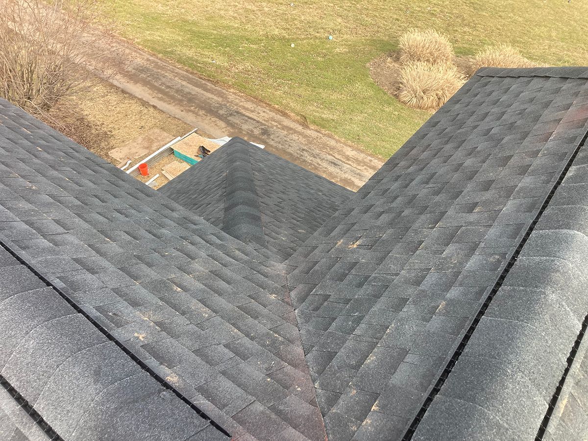 An aerial view of a roof with a playground in the background.