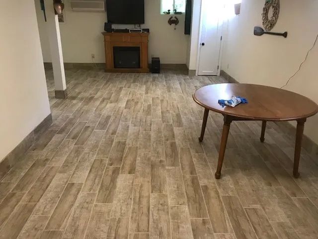 A living room with a wooden table and a fireplace.
