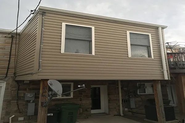 A house with a satellite dish on the side of it