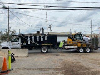 a dump truck with a tractor attached to it is parked in a parking lot .