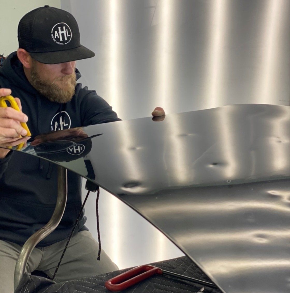 Man inspecting hail damage