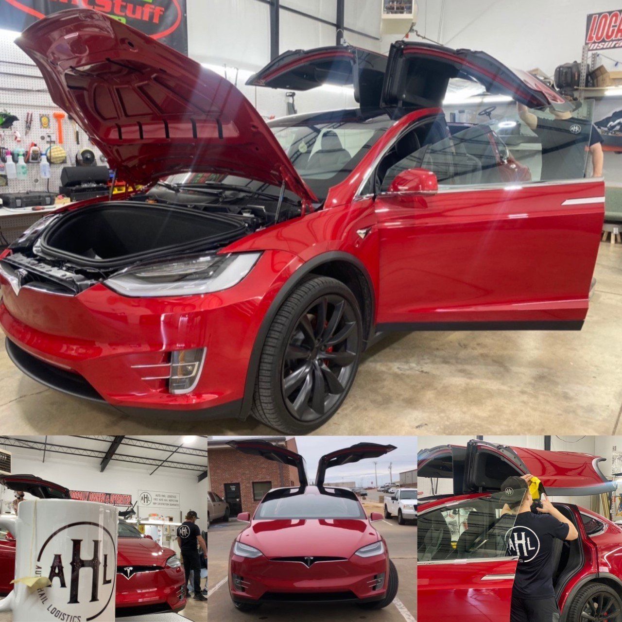 Red Tesla Model X with open doors in a shop, being worked on.
