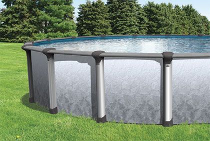 A large swimming pool is sitting on top of a lush green lawn.