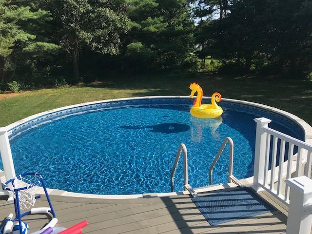 A large swimming pool with a swan float in it.