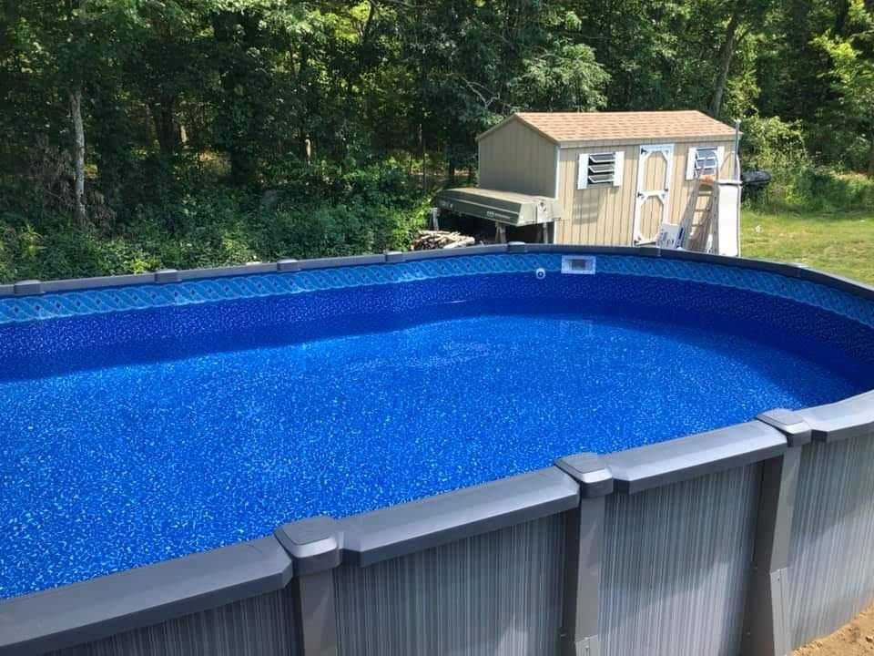 A large swimming pool with a shed in the background.