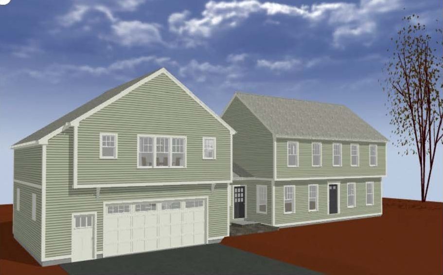 Two-story green houses with garage and driveway under a blue sky.