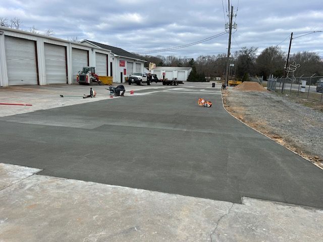 A road with a lot of equipment and trucks in the background