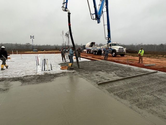 a group of people standing around a concrete slab