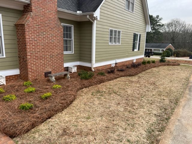 a house with a brick chimney and a lush green lawn in front of it