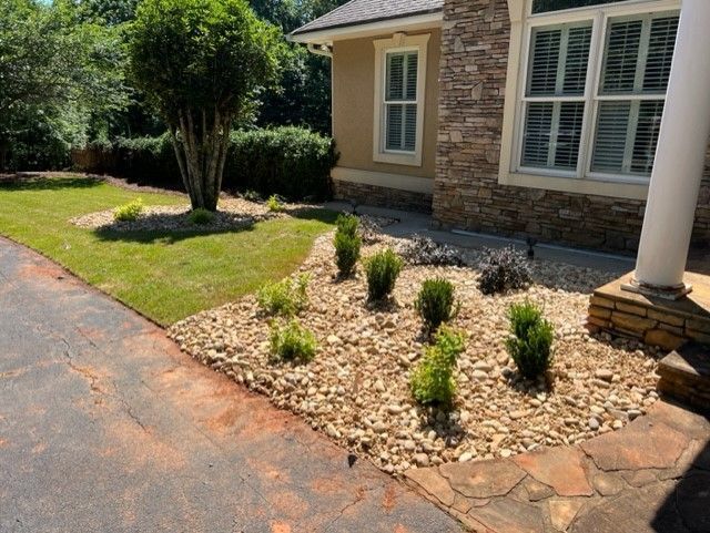 a house with a lush green lawn and a driveway in front of it