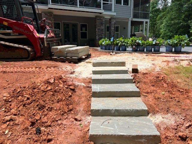 a concrete walkway is being built in front of a house