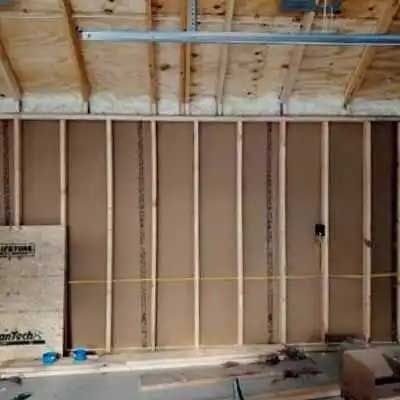 A wooden wall is being built in a garage.