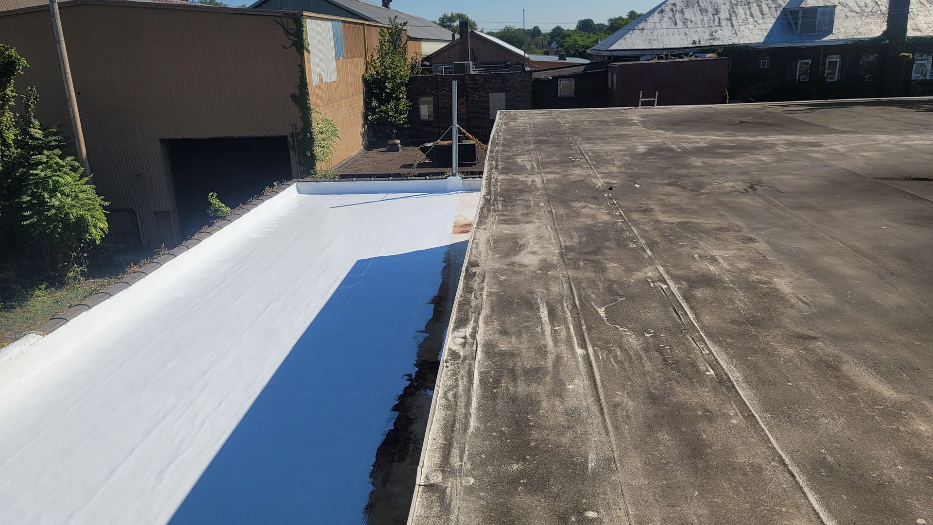 A concrete roof with a white coating on it.