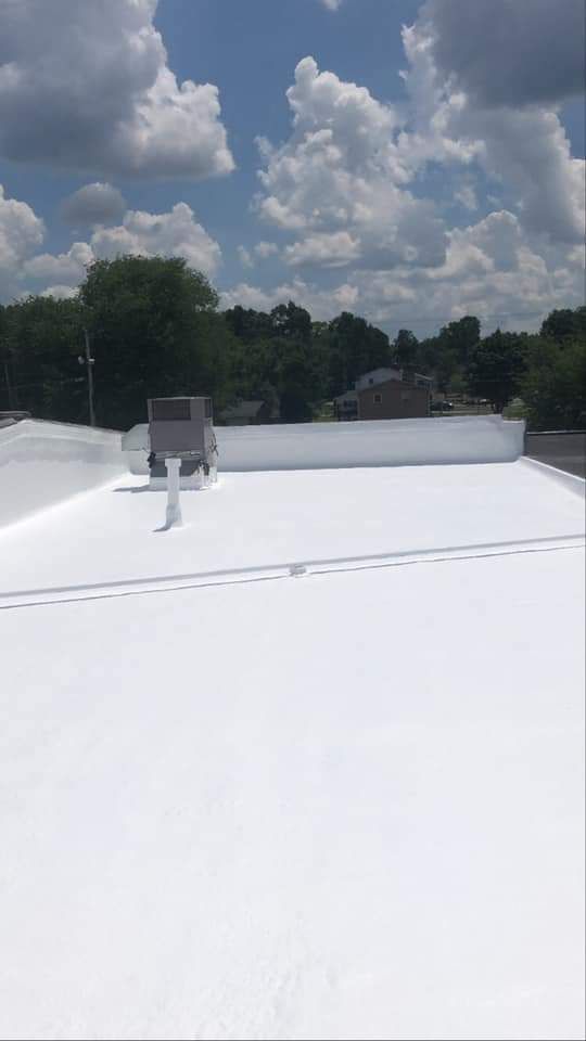 A white roof with a chimney on top of it.