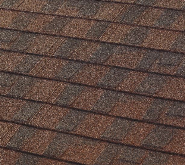 A close up of a roof with brown shingles