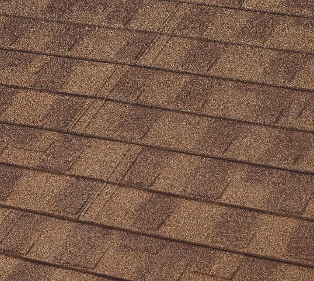 A close up of a brown roof with shingles.