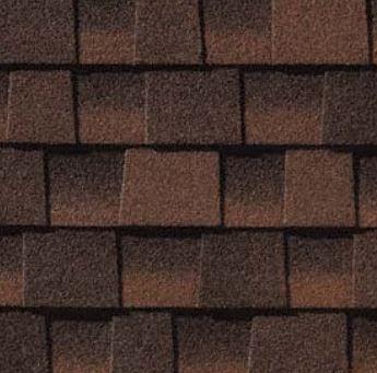 A close up of a row of brown shingles on a roof.