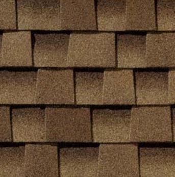 A close up of a row of brown shingles on a roof.
