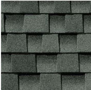 A close up of a row of gray shingles on a roof.