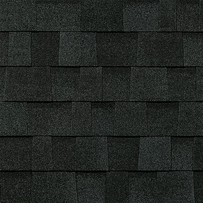 A close up of a roof with black shingles.
