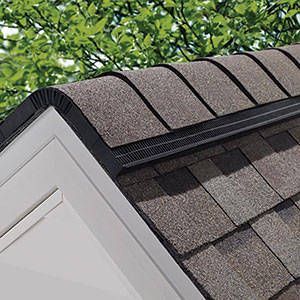 A close up of a roof of a shed with a gutter on it.