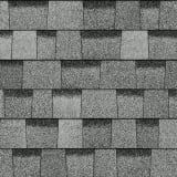 A close up of a row of gray shingles on a roof.