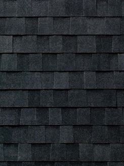 A close up of a black roof tile texture.