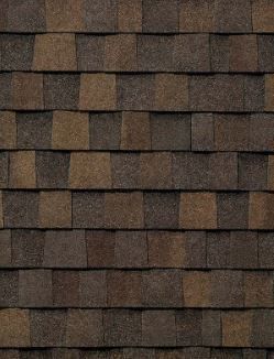 A close up of a row of brown shingles on a roof.