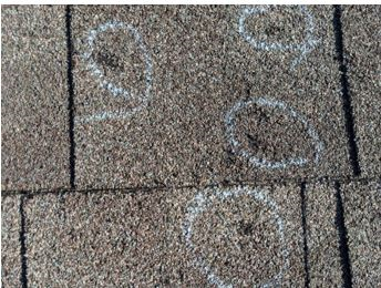 A close up of a roof with circles drawn on it.