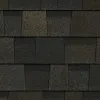 A close up of a row of black tiles on a roof.
