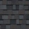 A close up of a row of black shingles on a roof.