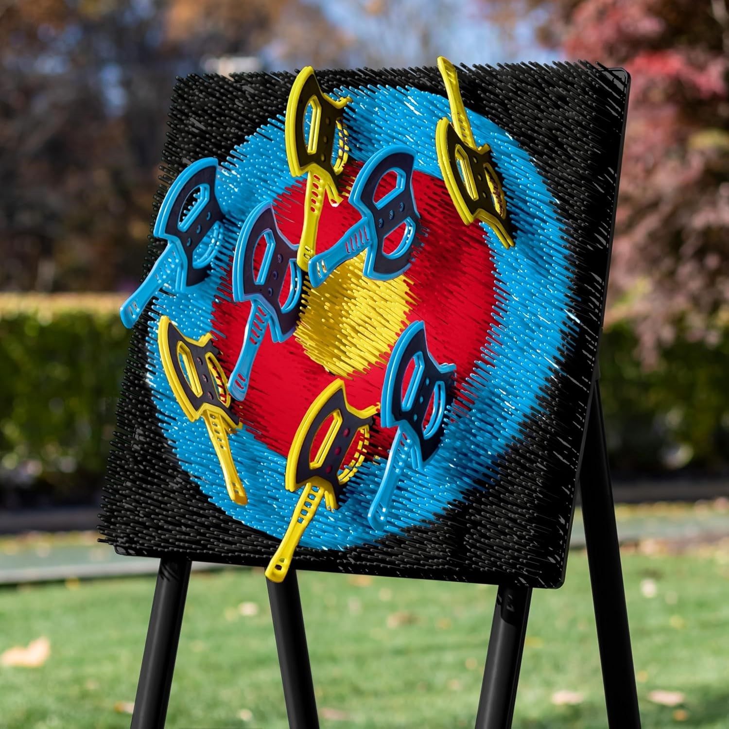 A painting of a target with scissors attached to it