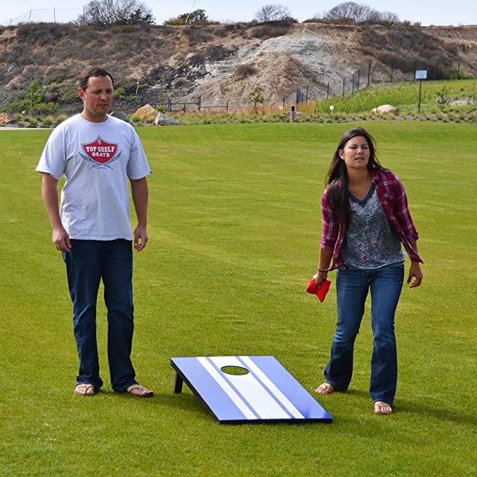 Man and woman playing cornhole