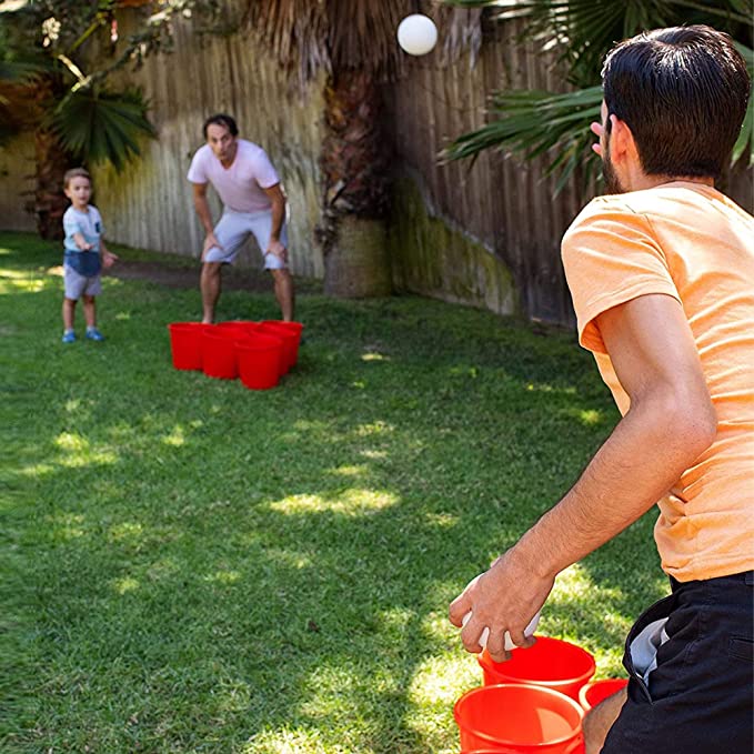 Men playing giant outdoor yard pong