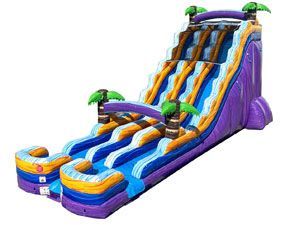 A large inflatable water slide with palm trees