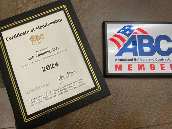 Certificate of Membership from ABC for J&P Roofing, LLC (2024) and ABC member sign with US flag.