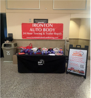 A table with a sign that says Ironton Auto Body
