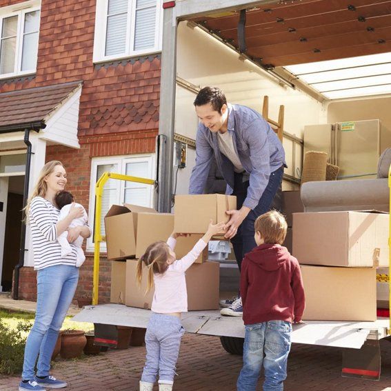 man holding box with his family