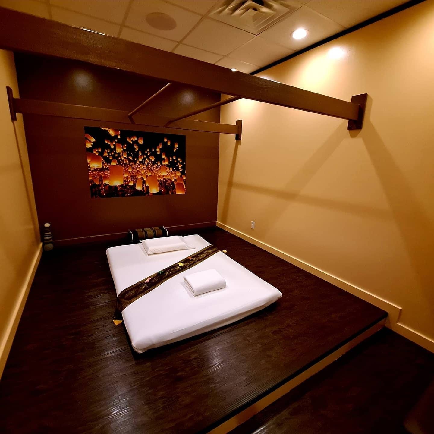 A room with two beds and a painting on the wall