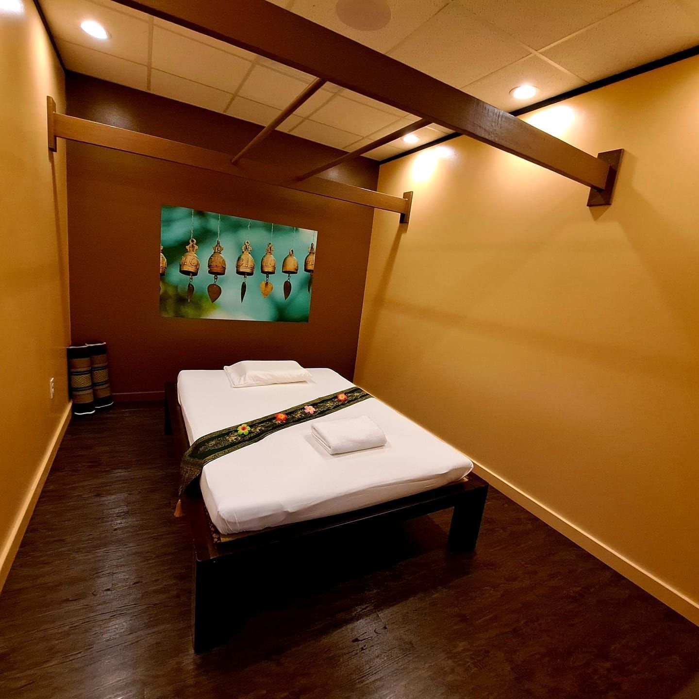 A room with two beds and a painting on the wall