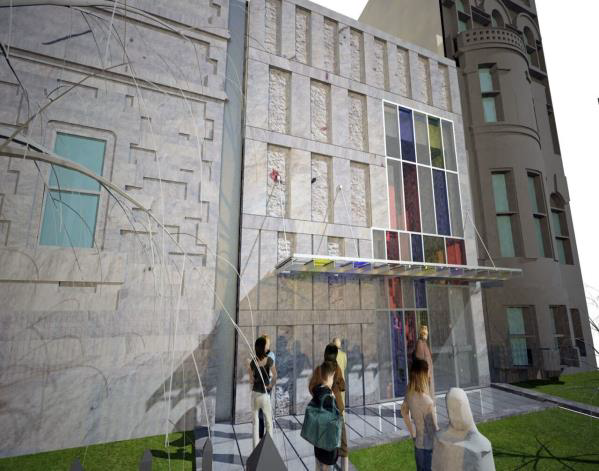 People standing outside a building with a colorful mural and ladder on a grassy courtyard.