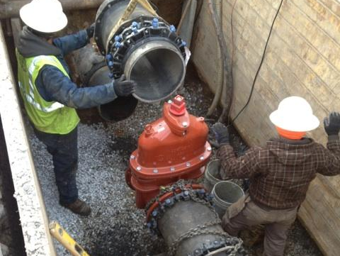 workers fixing sewer pipe