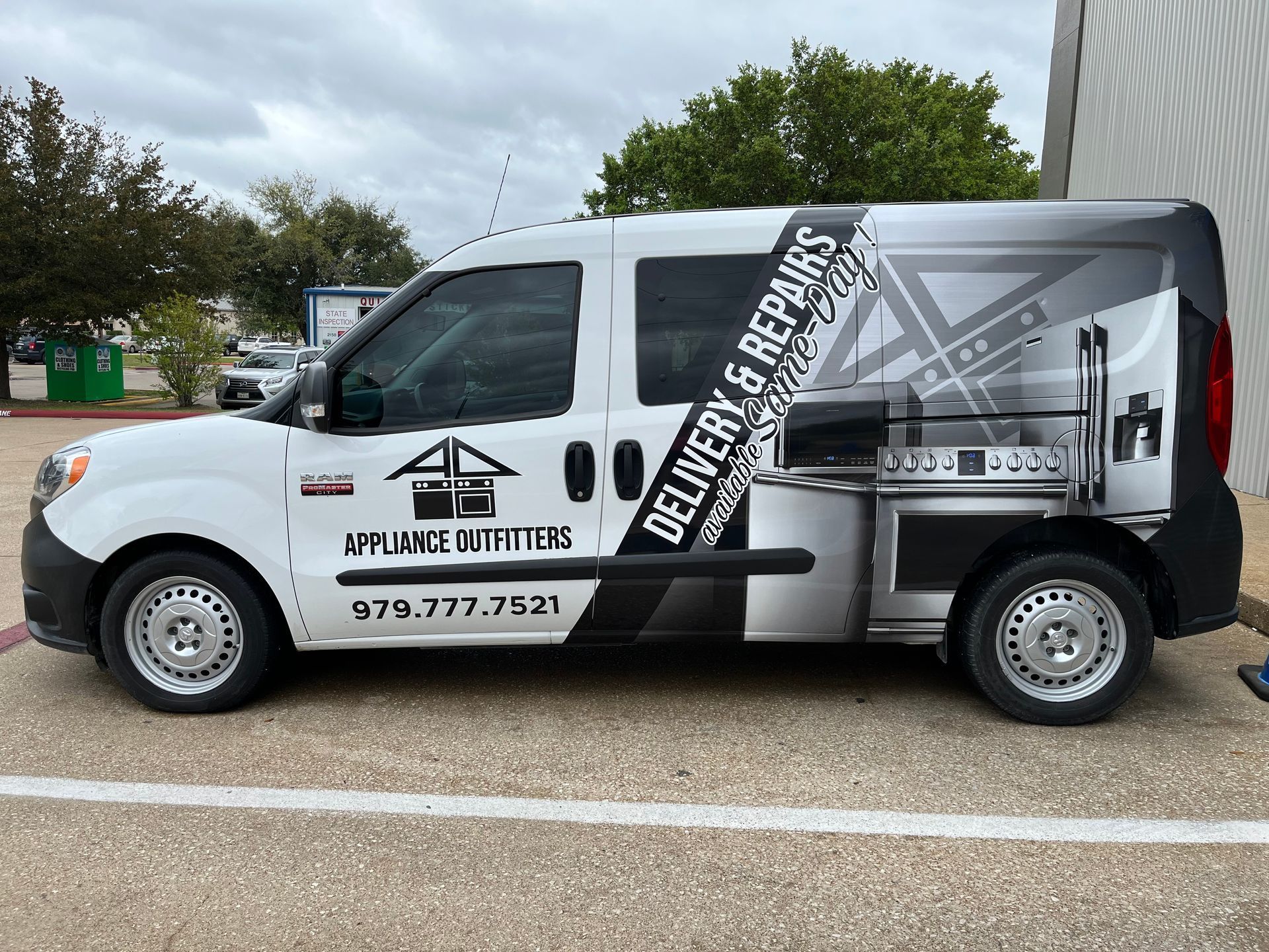a delivery and repair van is parked in a parking lot.
