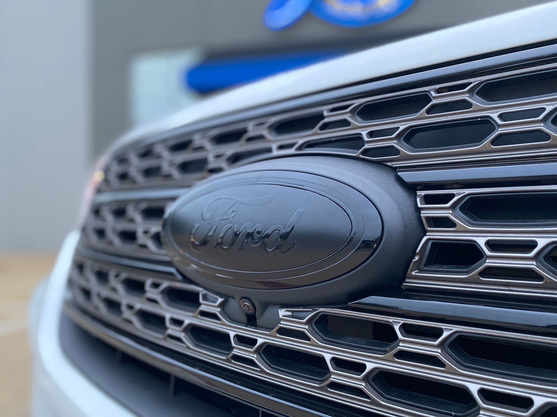 a close-up of the front grille of a ford car.