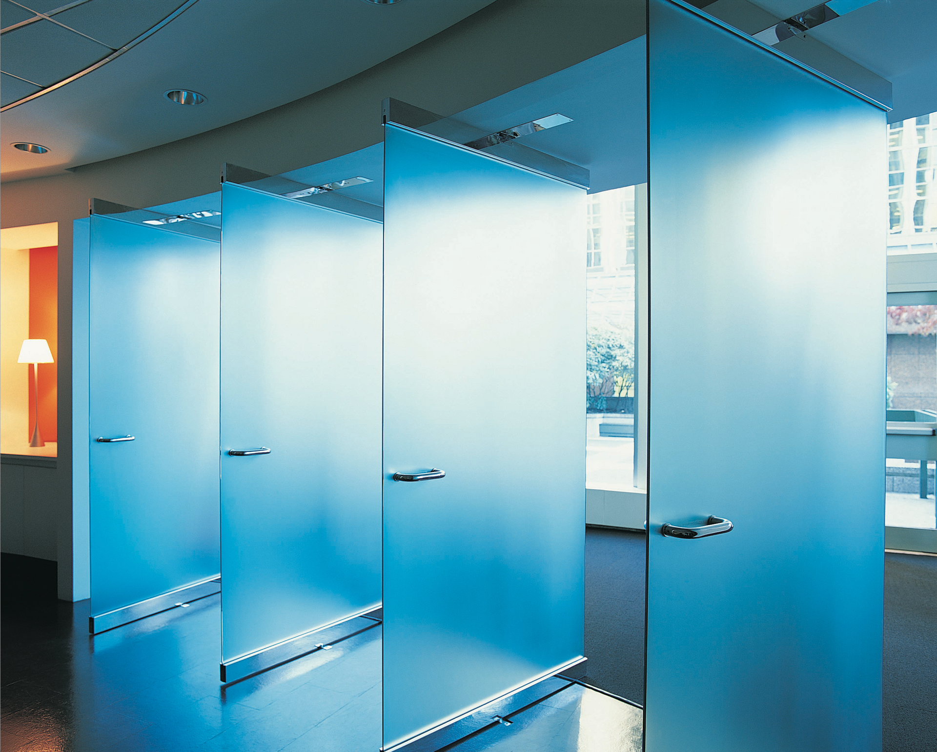 A room with a lot of blue glass walls